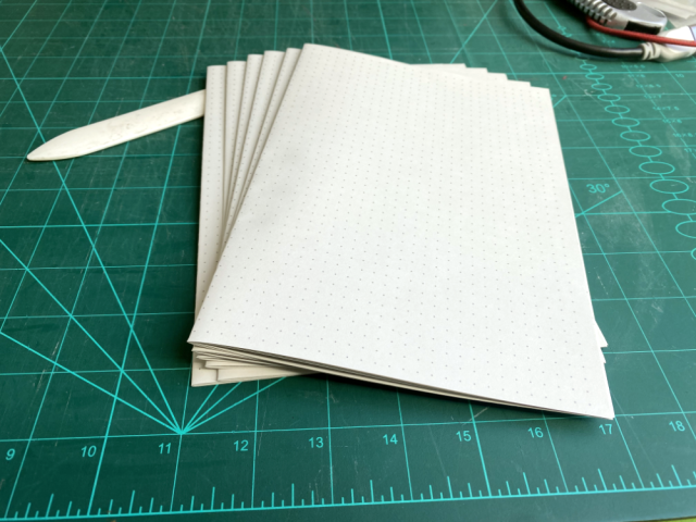 6 signatures á 5 sheets folded into A4 folios. A gray dot grid is printed on them. 6 signatures á 5 sheets folded into A4 folios. A gray dot grid is printed on them.