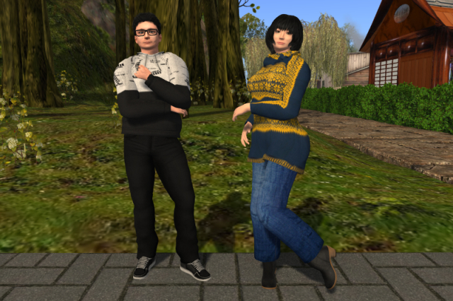 Myself on the left with a small forest in the background, wearing a light and dark grey hoodie, black jeans and black sneakers; Juno on the right, wearing a yellow and blue knit pullover dress, a pair of blue jeans and a pair of dark brown ankle boots