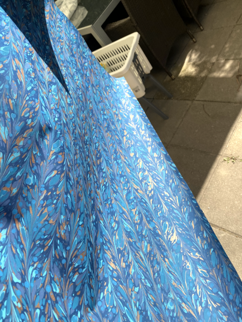 Turquoise paper with a pattern reminiscent of twines or fountains. There's different tones of turquoise with some gold blotches. Turquoise paper with a pattern reminiscent of twines or fountains. There's different tones of turquoise with some gold blotches.